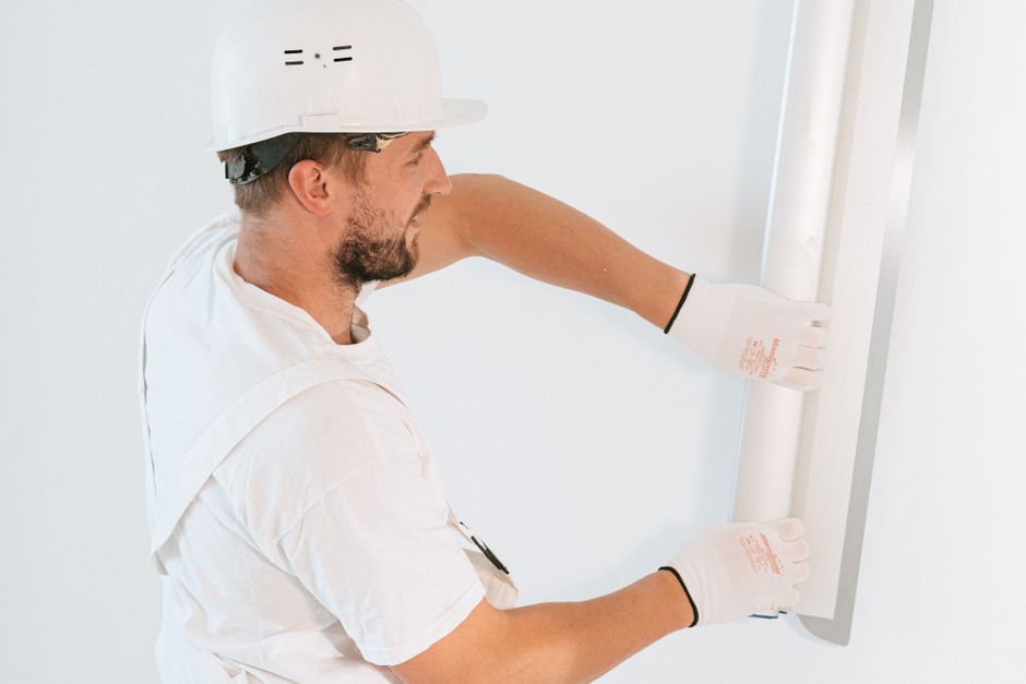 Skilled craftsman performing brick repointing with precision masonry tools
